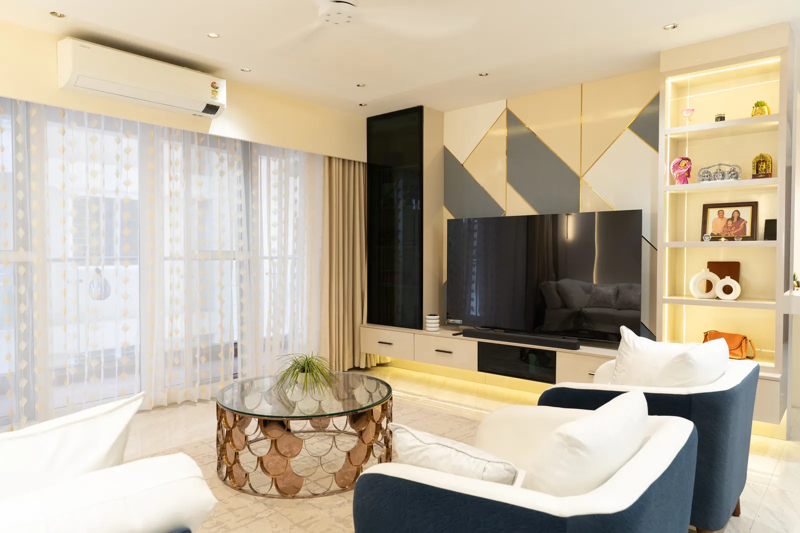 Living room with geometric TV wall and lit display shelves — Arna's Home